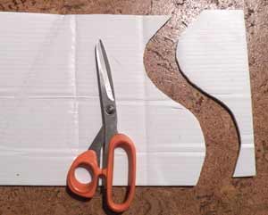 using scissors to cut corrugated plastic